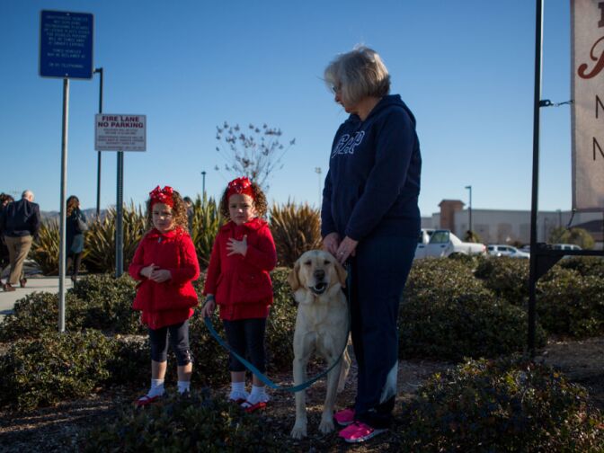Twins Saydee and Sophee Salcedo stand with their grandmother Mary Ann Taylor before Michael Crain's funeral on February 13th, 2013.