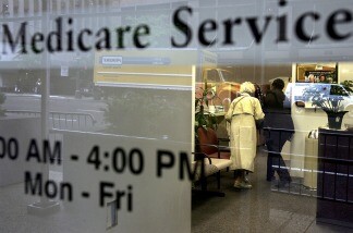 Two people walk inside a Medicare Services office.