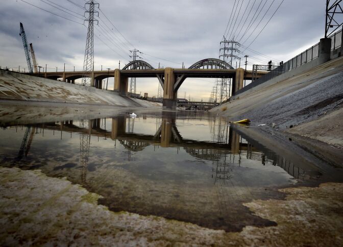The iconic 6th Street Bridge that connects downtown Los Angeles with its eastern disticts is reflected in the Los Angeles River after its closure to traffic on January 27, 2016.
The crumbling Sixth Street Viaduct that has appeared in scores of Hollywood productions will be closed and demolished due to safety concerns after its concrete has become weakened by a rare chemical reaction. / AFP / Mark Ralston        (Photo credit should read MARK RALSTON/AFP/Getty Images)