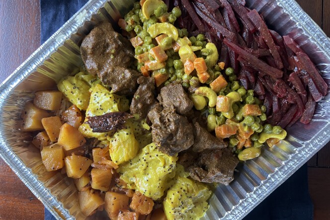 Colorful foods in an aluminum tray. 
