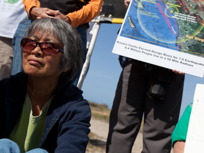 Katsuyo Fukuyama of Vista, Calif., listens to speakers at a protest near the San Onofre Nuclear Plant on April 6, 2012.