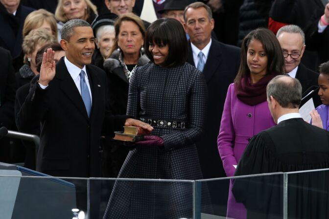 WASHINGTON, DC - JANUARY 21:  U.S. President Barack Obama (L) is sworn in during the public ceremony by Supreme Court Chief Justice John Roberts as First lady Michelle Obama, and daughters, Sasha Obama and Malia Obama look on during the presidential inauguration on the West Front of the U.S. Capitol January 21, 2013 in Washington, DC.   Barack Obama was re-elected for a second term as President of the United States.  (Photo by Alex Wong/Getty Images)