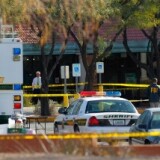 An FBI agent investigates the crime scene in front of the Safeway store a day after a person opened fire on a group of people on January 9, 2011 in Tucson, Arizona.