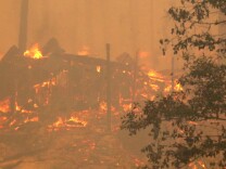 GROVELAND, CA - AUGUST 25:  A structure at a campground burns after being consumed by the Rim Fire on August 25, 2013 near Groveland, California. The Rim Fire continues to burn out of control and threatens 4,500 homes outside of Yosemite National Park. Over 2,000 firefighters are battling the blaze that has entered a section of Yosemite National Park and is currently 7 percent contained.  (Photo by Justin Sullivan/Getty Images)