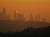 Caption:LOS ANGELES, CA - NOVEMBER 17: The downtown skyline is enveloped in smog shortly before sunset on November 17, 2006 in Los Angeles, California. Earlier this month, the South Coast Air Quality Management District, southern California?s anti-smog agency, approved a $36 million program to reduce pollution from trucks operating at the twin ports of Los Angeles and Long Beach. An estimated 12,000 diesel trucks travel to and from the ports each day, carrying freight through southern California metropolitan areas where their emissions are believed to increased risks of asthma and other illnesses among local residents and particularly children. (Photo by David McNew/Getty Images)
