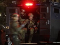 ATF agents board a truck to conduct a raid early Wednesday morning, May 17, 2017, in Los Angeles Twenty-one members and associates of MS-13 were arrested Wednesday morning as hundreds of federal and local law enforcement fanned out across Los Angeles, serving arrest and search warrants.