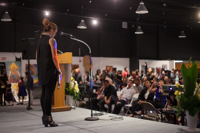 Kelly Pheng performs a spoken word piece, "History of a Dream," at the Cambodian Genocide Remembrance Day event at the Expo Arts Center in Bixby Knolls, (Long Beach), Calif. on Friday, April 17, 2015. The event was organized to bring awareness to the suffering of those under the Khmer Rouge and to bring together different generations to heal and remember the suffering and lives lost 40 years ago. 
