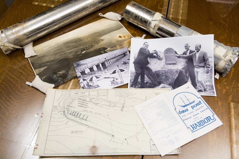 The Dana Point steel tube time capsule enclosed in a rock 50 years ago along with items from the time period or copies of items from the time capsule at Orange County Archives (Photo by LEONARD ORTIZ, ORANGE COUNTY REGISTER)