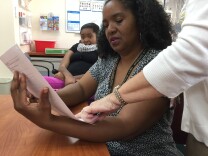 Sherri Brady reads up on what to expect today in the CHLA Rett Clinic.