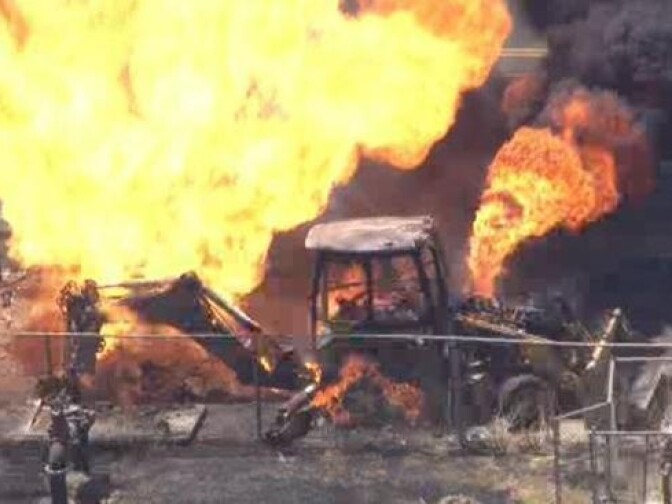 A gas main fire broke out in Woodland Hills Wednesday, setting a backhoe and nearby trees aflame. 