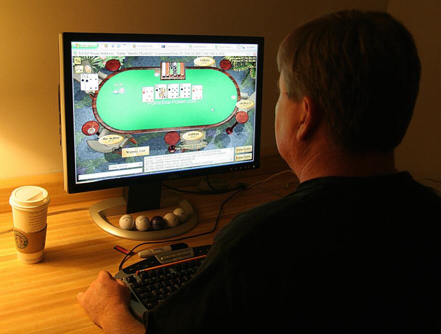 A man plays poker on his computer connected to an internet gaming site from his home in Manassas, VA 02 October, 2006. 