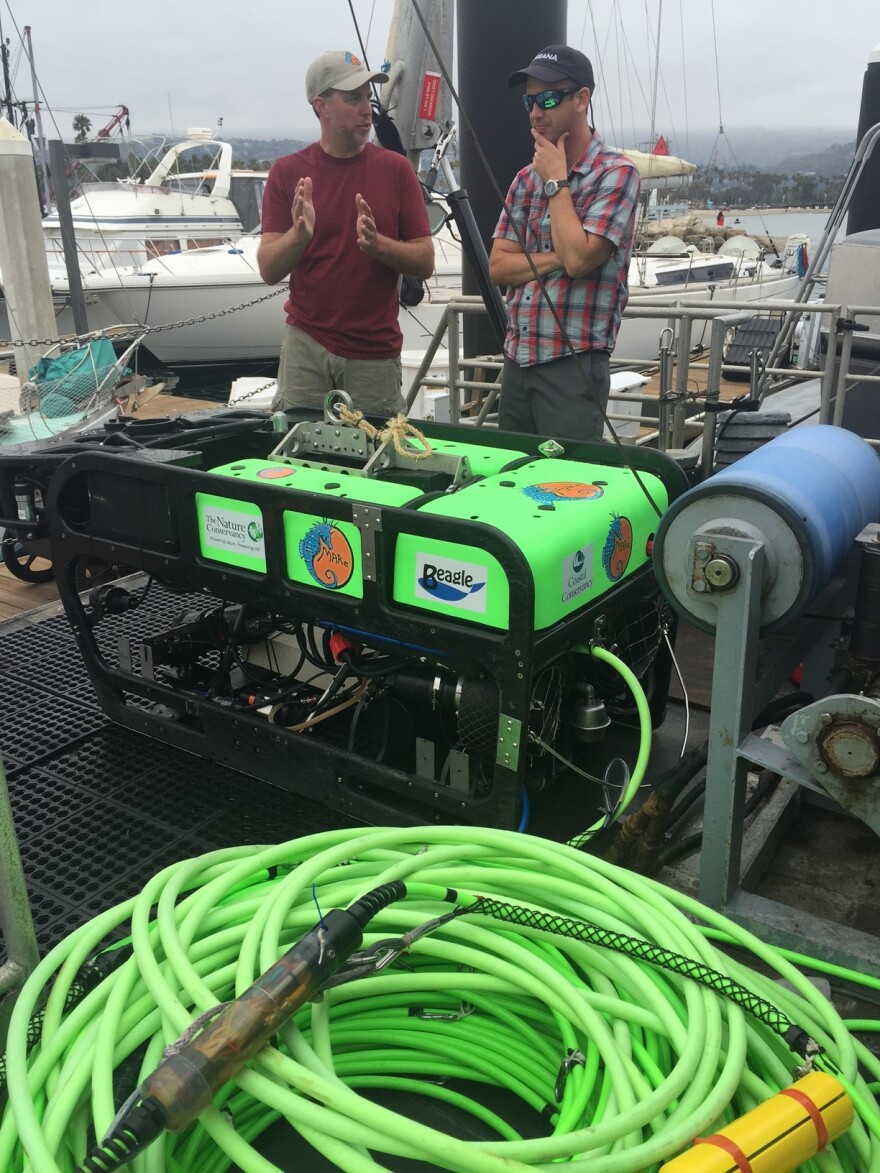 Ben Enticknap of Oceana and Dirk Rose of MARE stand next to the remotely operated underwater vehicle they'll use to map the ocean floor.
