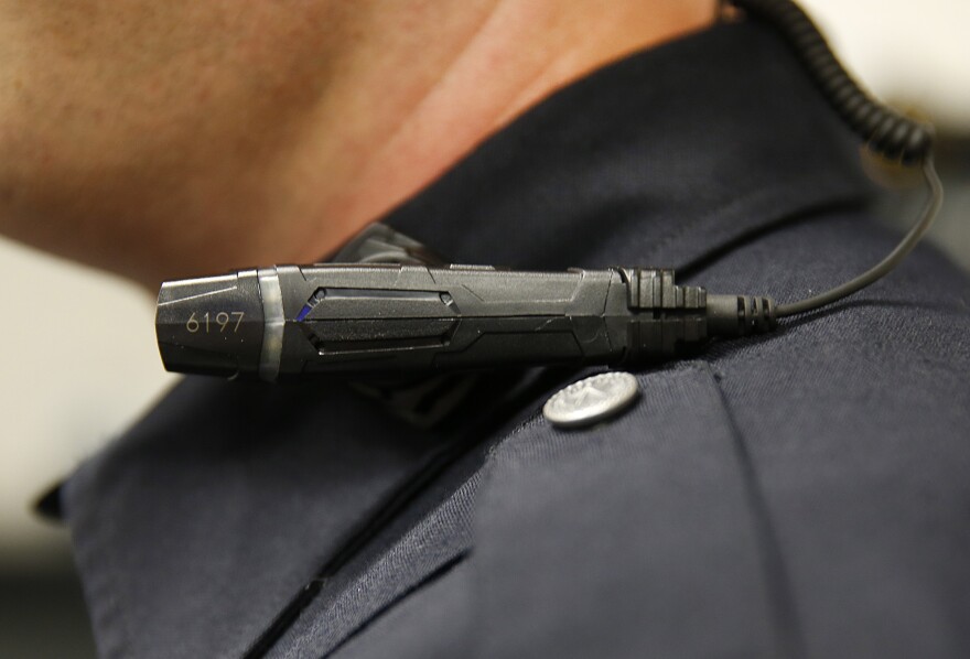 WEST VALLEY CITY, UT - MARCH 2: A West Valley City police officer shows off a newly-deployed body camera attached to his shirt collar on March 2, 2015 in West Valley City, Utah. West Valley City Police Department has issued 190 Taser Axon Flex body cameras for all it's sworn officers to wear starting today.  (Photo by George Frey/Getty Images)