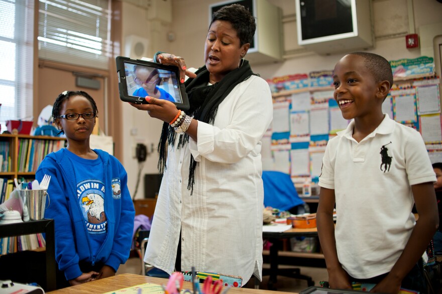 Second grade teacher Jacqueline Porter-Morris shows students how to take a picture for their iPad wallpaper for the first time on Friday, Nov. 15. Baldwin Hills is the final school to receive iPads as part of LAUSD's pilot program.