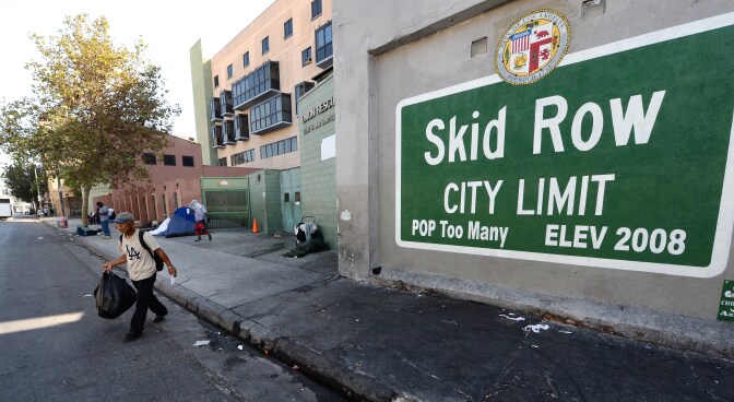 == With AFP Story by Veronique DUPONT: US-CALIFORNIA-POVERTY-HOMELESS ==
A sign reading "Skid Row" is painted on a wall next to the Los Angeles Mission, September 22, 2014 in Los Angeles, California.  Los Angeles' Skid Row contains one of the largest populations of homeless people in the United States.  AFP PHOTO / Robyn Beck        (Photo credit should read ROBYN BECK/AFP/Getty Images)