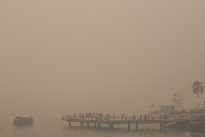 The president of Indonesia Monday apologized to nearby countries for the record-setting air pollution caused by wildfires in his country. (Photo: The Merlion is the only visible landmark on the bay as the Singapore skyline is completely covered in smoke haze on June 21, 2013).  