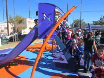 Children line up to go down the slide at the Avalon and Gage Park's grand opening, Jan. 24, 2015.