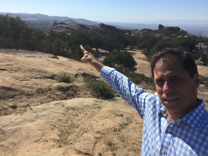 NBC4's Joel Grover points to the Santa Susana Field Lab from the Sage Ranch Park in the Simi Valley.