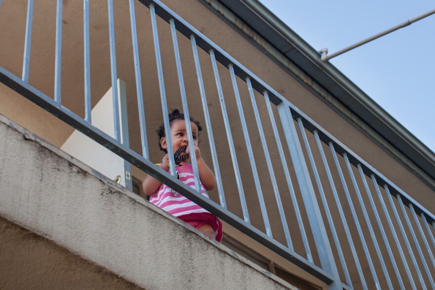 Lola Mae Bray looks out of the second floor of the Community Prisoner Mother Program in Pomona, Calif. where children under age seven live with their incarcerated mothers. The children are enrolled in preschool, Head Start or Kindergarten classes on-site, while the mothers take parenting, drug and alcohol abuse prevention and other classes.