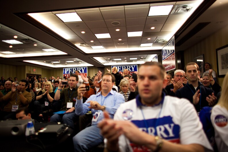 WEST DES MOINES, IA -  JANUARY 3:  Supporters cheer while Republican presidential candidate, Texas Gov. Rick Perry speaks with potential voters during a caucus training session held at the Sheraton January 3, 2012 in West Des Moines, Iowa. After months of campaigning by candidates, Iowan voters throughout the state prepare to participate in the first caucus of the 2012 presidential election.   (Photo by Jonathan Gibby/Getty Images)