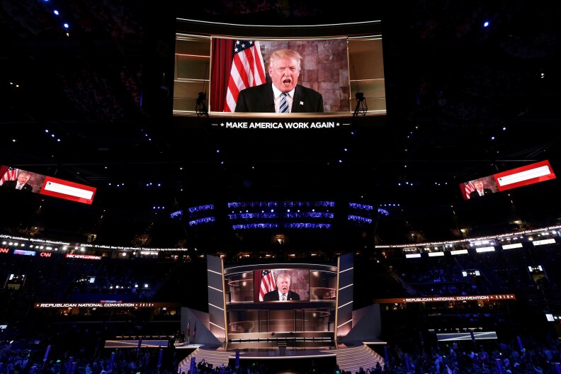 CLEVELAND, OH - JULY 19:  Republican presidential candidate Donald Trump is seen speaking on a screen from New York City, on the second day of the Republican National Convention on July 19, 2016 at the Quicken Loans Arena in Cleveland, Ohio. Republican presidential candidate Donald Trump received the number of votes needed to secure the party's nomination. An estimated 50,000 people are expected in Cleveland, including hundreds of protesters and members of the media. The four-day Republican National Convention kicked off on July 18.  (Photo by Alex Wong/Getty Images)