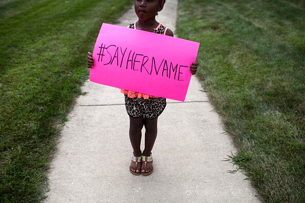 LISLE, IL  - JULY 25: Daija Belcher, 5, holds a sign in front of the DuPage African Methodist Episcopal Church during the funeral service for Sandra Bland on July 25, 2015 in Lisle, Illinois. Bland's death roused suspicion nationwide after the 28-year-old was found hanging from a plastic bag three days after she was pulled over by a Texas State Trooper for a traffic violation. (Photo by Jonathan Gibby/Getty Images)