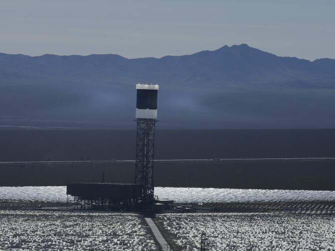Some of the 300,000 computer-controlled mirrors, each about 7 feet high and 10 feet wide, reflect sunlight to boilers that sit on 459-foot towers. The sun's power is used to heat water in the boilers' tubes and make steam, which in turn drives turbines to create electricity Tuesday, Feb. 11, 2014 in Primm, Nev. The Ivanpah Solar Electric Generating System, sprawling across roughly 5 square miles of federal land near the California-Nevada border, will be opened formally Thursday after years of regulatory and legal tangles. (AP Photo/Chris Carlson)