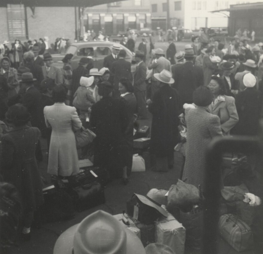 In a photo taken May 29, 1942, Japanese-Americans wait in Los Angeles to board a train that would take them to a camp in Parker, Ariz. called the Poston War Relocation Center. 