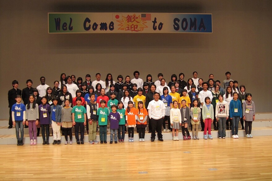 YOLA, Soma Children's Chorus, and El Sistema Japan pose as a group.