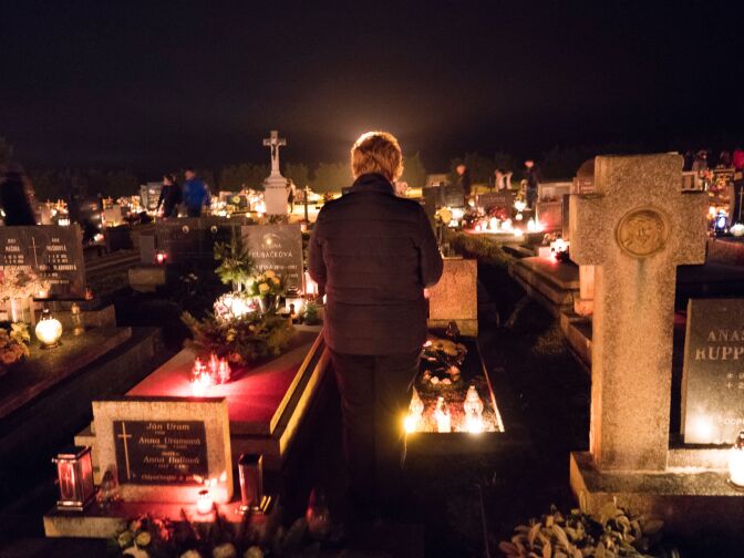 People visit a cemetery to pay respects to their ancestors on All Saints Day in the northern Slovakian village of Bobrovec on November 1, 2016.