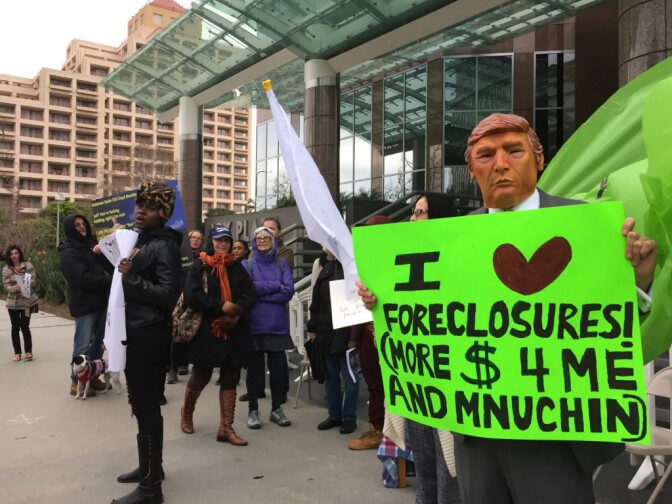 Community activists protest the nomination of Steven Mnuchin as Treasury Secretary outside the Goldman Sachs offices in Century City, and later, Mnuchin's Bel Air home. 