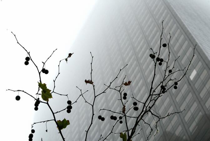 In this file photo, a dense cloud fogs downtown Los Angeles. The National Weather Service forecasts cooler temperatures and chances of rain in the next few days as L.A. County's beaches see big waves. 