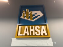 A sign says "LAHSA" with a logo atop. 
