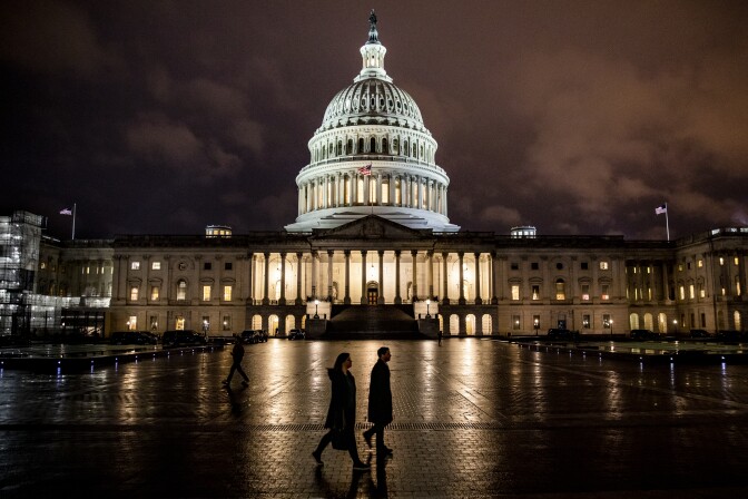 WASHINGTON, DC - DECEMBER 17: People walk along the east front plaza of the US Capitol as night falls on December 17, 2019 in Washington, DC. The House Rules Committee is holding a full committee hearing to set guidelines for the upcoming debate and vote on the two Articles of Impeachment of President Trump in the House of Representatives. (Photo by Samuel Corum/Getty Images)
