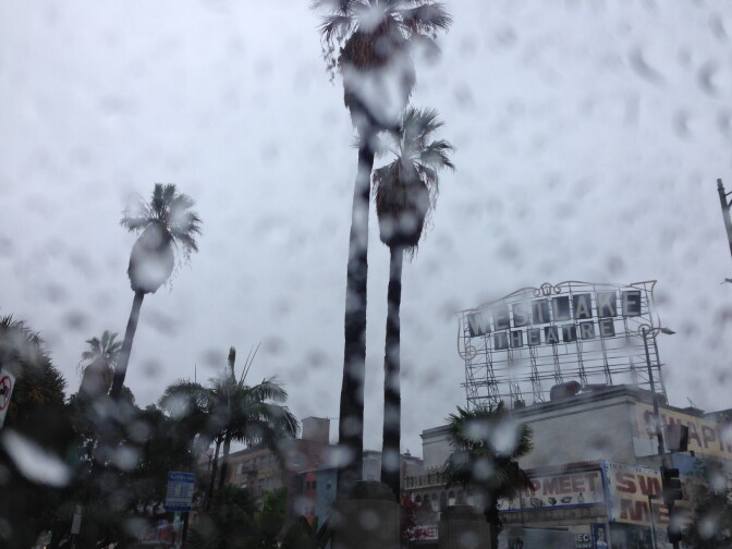 A view of the Westlake Theater on Wilshire Boulevard seen through a rainy car window Friday morning, Dec. 16, 2016.