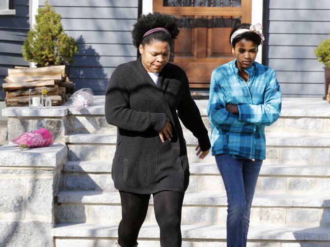 Two women leave after placing flowers on the doorstep of the Richard house in the Dorchester neighborhood of Boston, Tuesday, April 16, 2013. Martin Richard, 8, was killed in Monday's bombings at the finish line of the Boston Marathon. The boy’s mother, Denise, and 6-year-old sister, Jane, were badly injured.