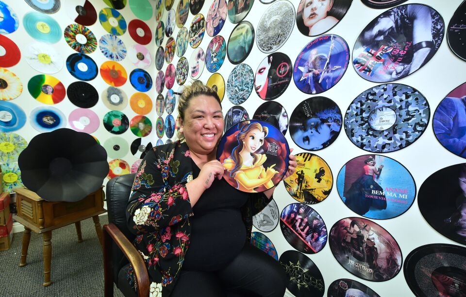 Ma Nerriza dela Cerna of Erika Records displays a full color "Beauty and the Beast" record on April 12, 2017 at the company's office in Buena Park, California where employees have been pressing vinyl for more than 30 years.