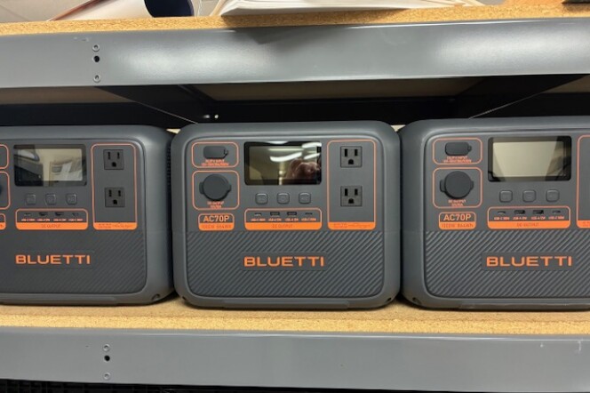 Gray portable backup power batteries on a shelf. 
