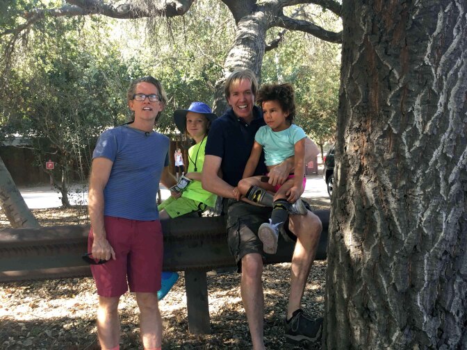 TV writer John Pardee is pictured with his family. He barely took time off of work when he and his husband adopted their first child.