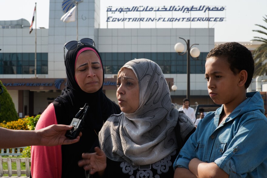CAIRO, EGYPT - MAY 19: Mervit Mounir, left, and Answar Moissen, talk with journalists in front of the Egypt Air In flight services building where family and friends of the Egypt Air flight are gathering on May 19, 2016 in  Cairo,  Egypt. Their relative was on the plan, they last talked with her when she was recently married. EgyptAir flight MS804 from Paris to Cairo carrying 66 passengers and crew vanished over the eastern Mediterranean last night. (Photo by David Degner/Getty Images).