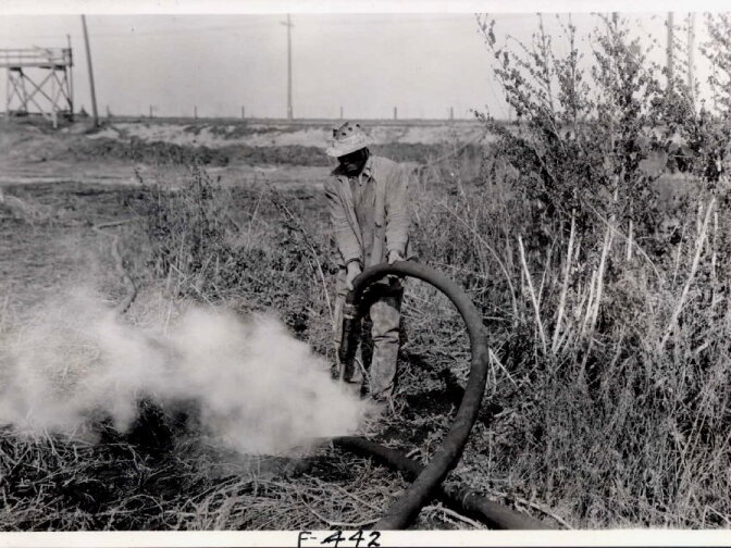 From Dec. 28, 1927: "A peat fire that began July 1923 from a peat bog under an old river began as a relatively small smoldering blaze that covered two acres and eventually spread to fifteen acres. City officials were unable to put out the many fires that continued to erupt until four years later when City Engineer Shaw diverted Centinela Creek into an eight-foot wide by two-foot deep channel through the peat bog beds. Here we see a worker jetting water at active fires at the westerly side of a peat fire above the level of flood water pond."