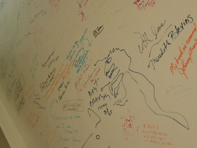Bradbury signed and drew a dinosaur on the Bookstore signature wall.