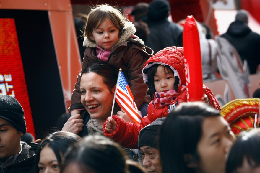 NEW YORK, NY - JANUARY 29:  Thousands of people line the streets of New York's Chinatown to see the Chinese New Year parade on January 29, 2012 in New York City. This year celebrates the Year of the Dragon.  (Photo by John Moore/Getty Images)