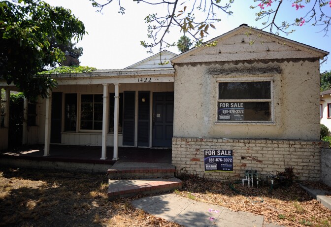 For sale signs are posted on a foreclosed house on Sept. 15, 2011 in Glendale.