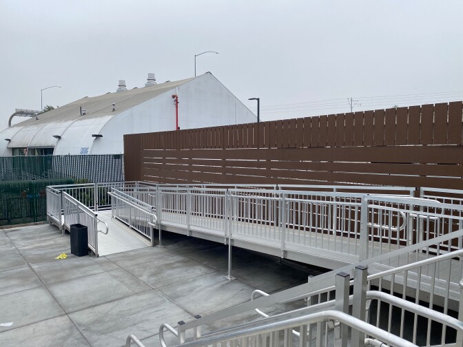A large wheelchair ramp leads to a shelter.