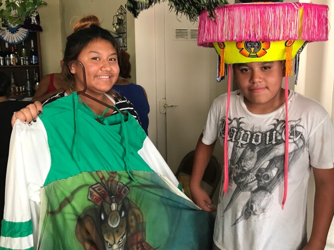 Brother and sister Prisila and Rey López show off Rey's Chinelos costume. The centuries-old Chinelos dance started as a veiled way to mock the Spanish colonists, July 27, 2017.