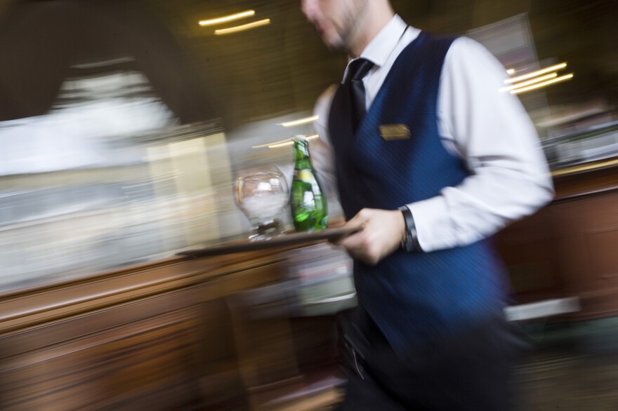 A waiter works in a French brasserie "Le Train Bleu", on April 11, 2013 in Paris. AFP PHOTO / FRED DUFOUR
