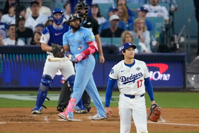 Shohei Ohtani and Vladimir Guerrero Jr turn to watch Guerrero's home run ball.