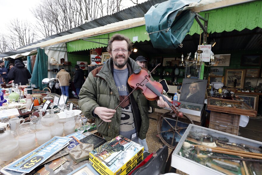 A man holds a violin on March 17, 2013 at the National Antiques and Ham Fair in the western Paris suburb of Chatou.