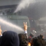 Egyptian demonstrators confront riot police during a demonstration in Cairo on January 28, 2011, demanding the ouster of President Hosni Mubarak.